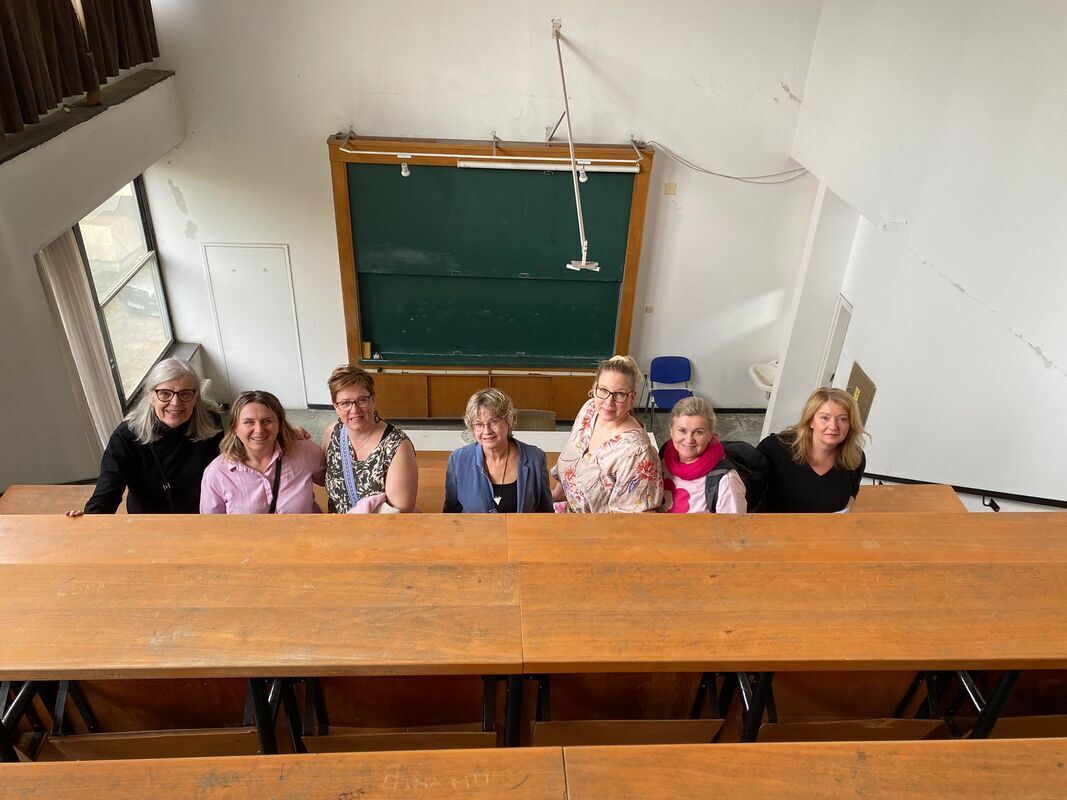 1000014722.jpg A group of women in a classroom, Alvar Aalto inspired architecture.