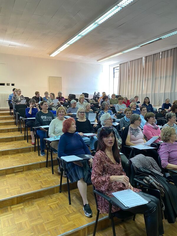 1000014740.jpg A group of people sitting in a classroom.