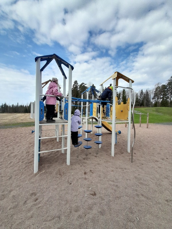 Lapset leikkivät kiipeilytelineessä