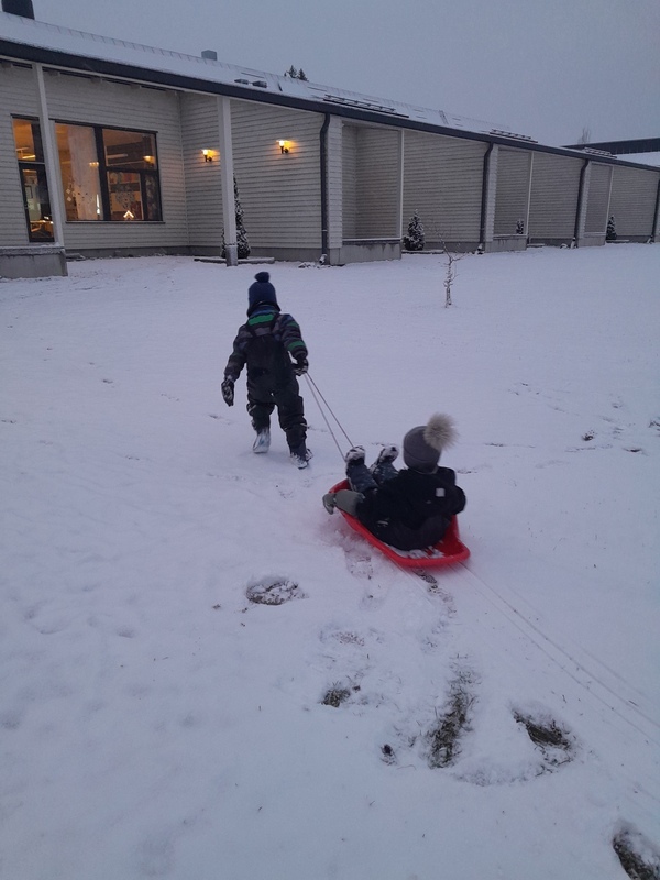 20241203_085619.jpg Lapsi vetää toista lasta pulkassa.