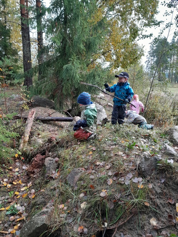 Lapsia leikkimässä metsässä.