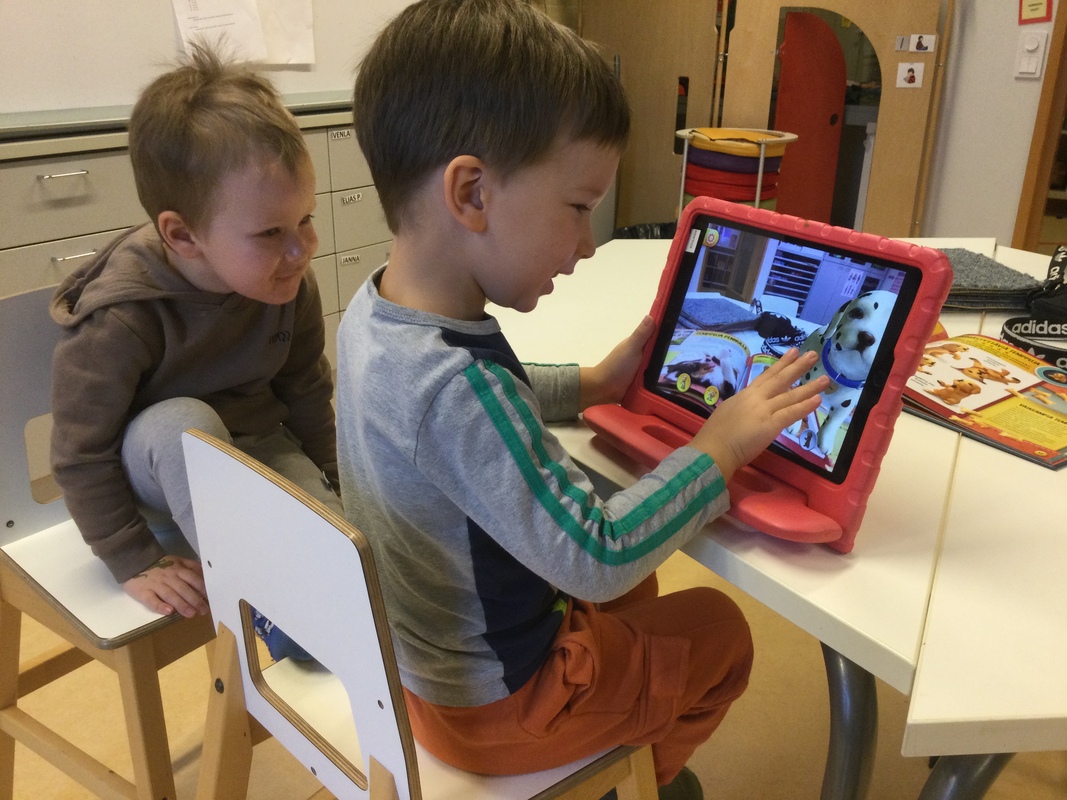 Kaksi lasta lukee virtuaalikirjaa.