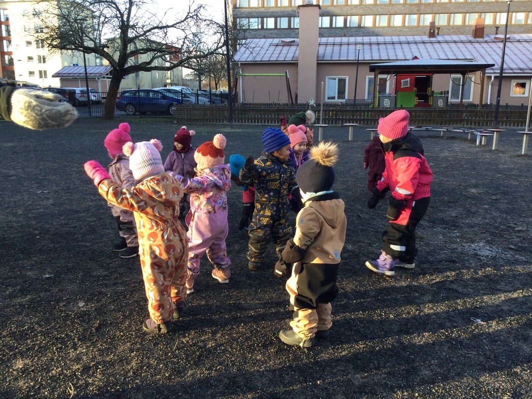 Lapset liikkuvat liikuntaleikkejä pihalla.