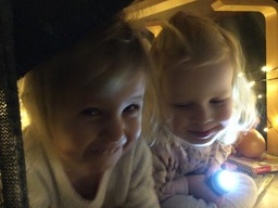 Lapset kurkkivat valomajasta.