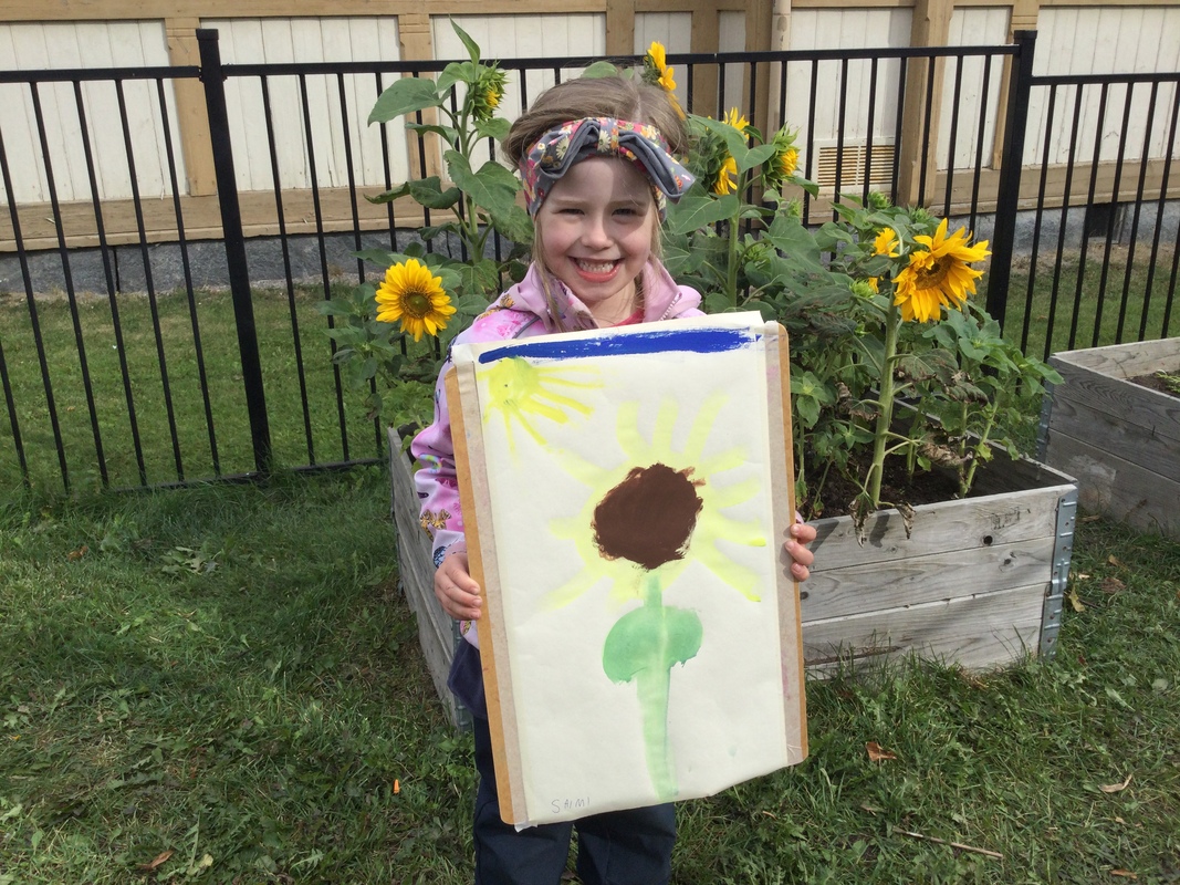 Auringonkukkamaalaus tytöllä