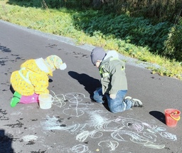 Lapset piirtämässä katuliiduilla