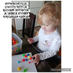 Lapsi laittaa nuppeja alustaan
