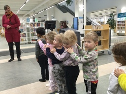 Lapset pitävät käsiään toistensa olkapäillä jonossa ollessaan.