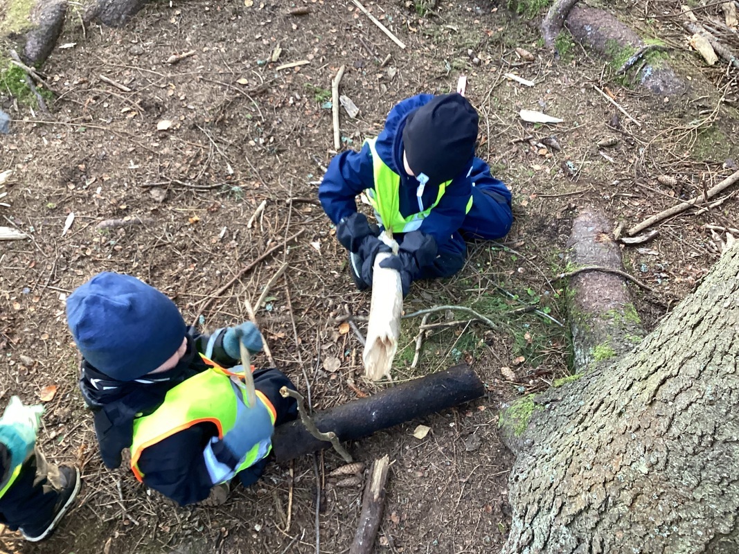 Lapset metsässä leikkimässä.